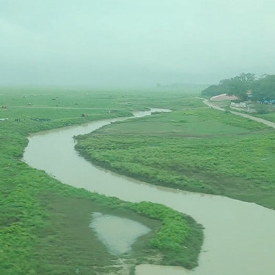 outside-view-from-running-train-crossing-metal-bridge-over-ganga-river-uttar-pradesh-india