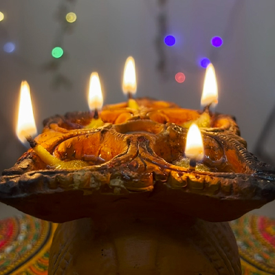 diya-with-lights-in-background-on-diwali-look-happy-diwali