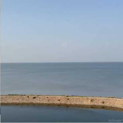 flat-ocean-horizon-and-small-pond-near-the-ocean-stock-footage-video